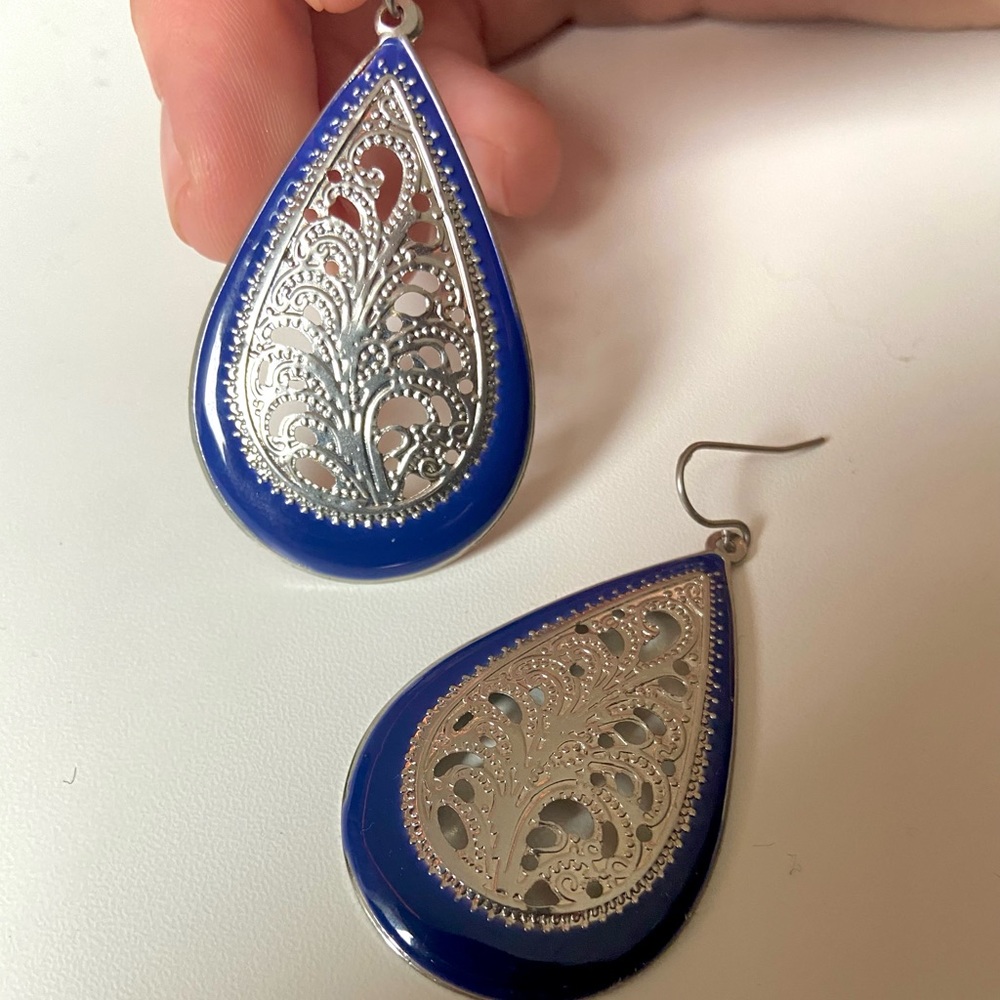 Silver and navy dangling earrings.